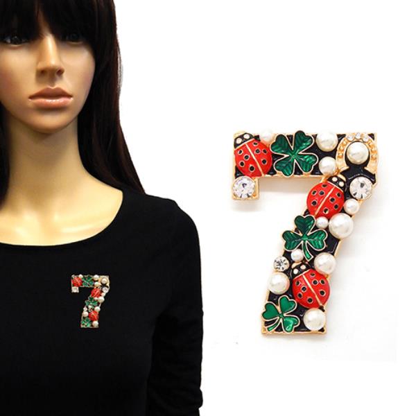 BROOCH IN THE SHAPE OF THE NUMBER SEVEN DECORATED WITH RED LADYBUGS, GREEN CLOVERS, PEARLS, AND CRYSTALS