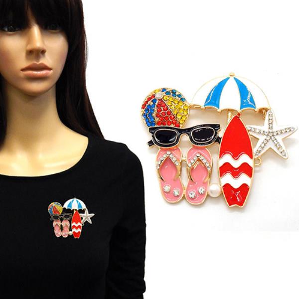 BEACH-THEMED BROOCH IS COMPOSED OF SEVERAL ICONIC SUMMER MOTIFS